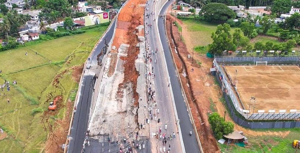 Aerial view of the collapsed elevated National Highway 66 at Kooriyad, Kerala, with debris and damaged service roads.