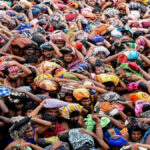 Devotees receiving traditional Kerala Sadhya during Annadanam at Sabarimala temple with steel plates and glasses.