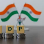 Workers and traffic in a busy Indian market area, symbolizing economic activity in India.