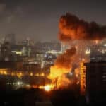 Firefighters and emergency workers respond to damaged residential buildings in Kyiv after overnight Russian missile strikes.