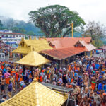 A long queue of devotees waiting for darshan at Sabarimala Sannidhanam during the Mandala season, with crowd control arrangements in place.
