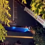 Tourists stranded in the Sky Dining platform suspended 120 feet in the air in Munnar, while rescue teams attempt to lower the structure after a crane malfunction.