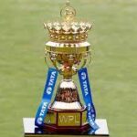 Action-packed Women’s Premier League 2026 match preview featuring Mumbai Indians and Royal Challengers Bengaluru players, with stadium lights and enthusiastic crowd in the background.