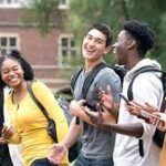 A US university campus with students walking, representing new federal loan rules limiting borrowing for professional graduate degrees to $200,000 starting in 2026.