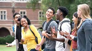 A US university campus with students walking, representing new federal loan rules limiting borrowing for professional graduate degrees to $200,000 starting in 2026.