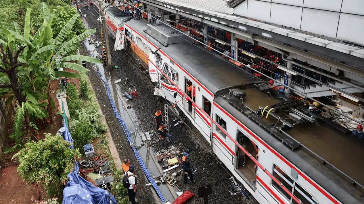 Wreckage after deadly train crash near Jakarta Indonesia with rescue teams working on site